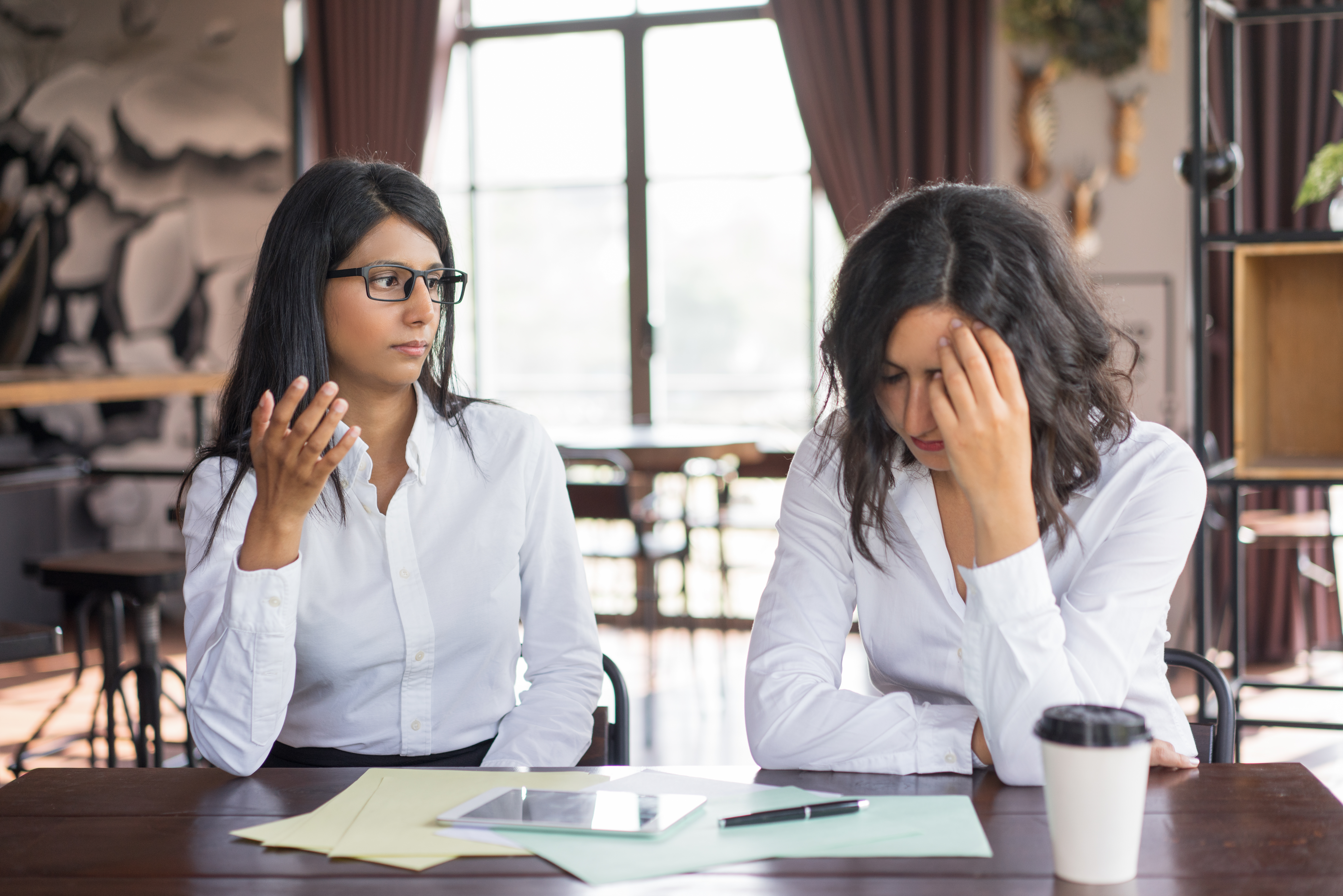 Two women in serious discussion.