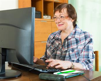 Elderly woman working with computer