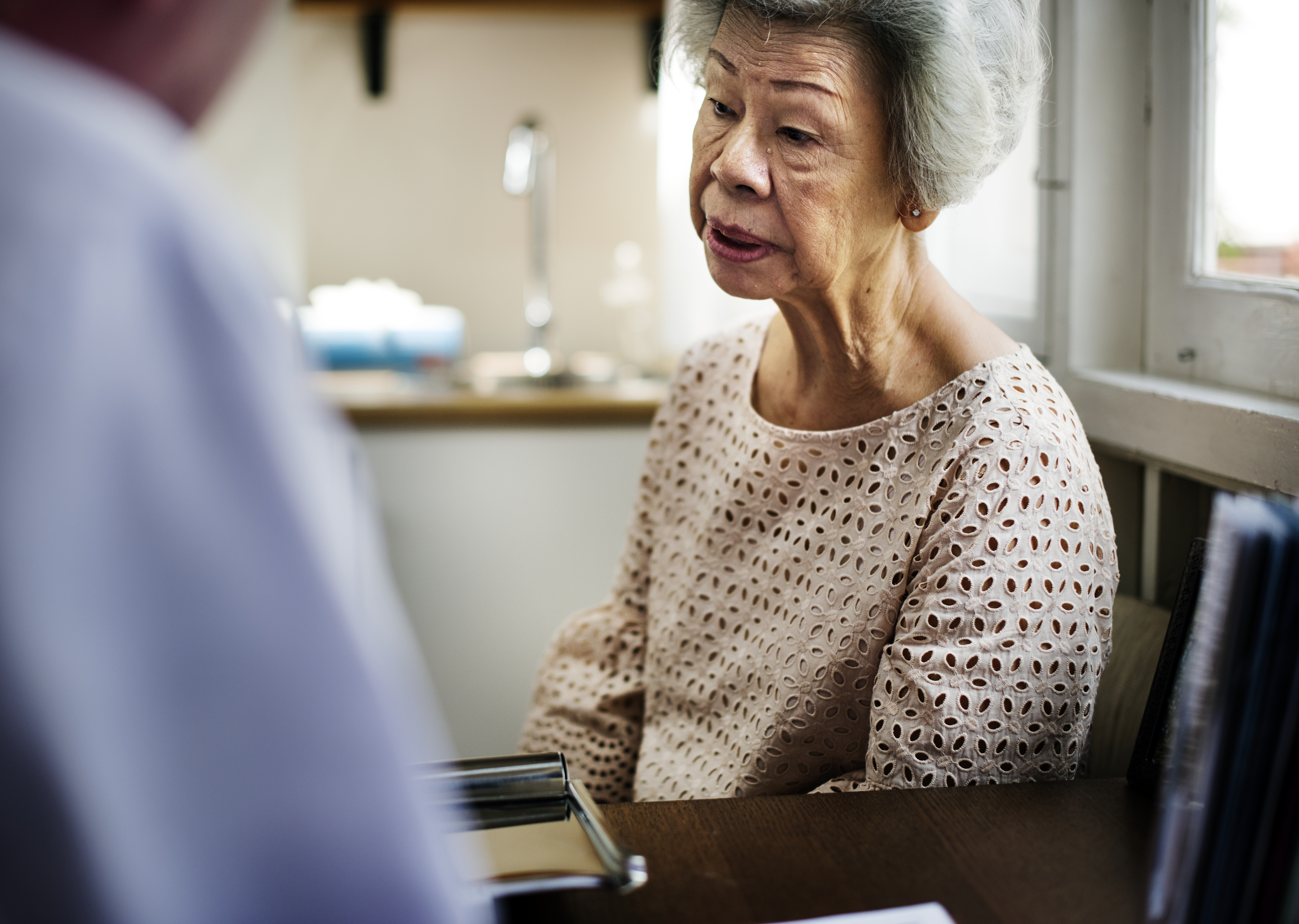 Asian woman meeting doctor