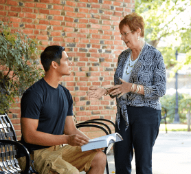 Faculty member talking with student.